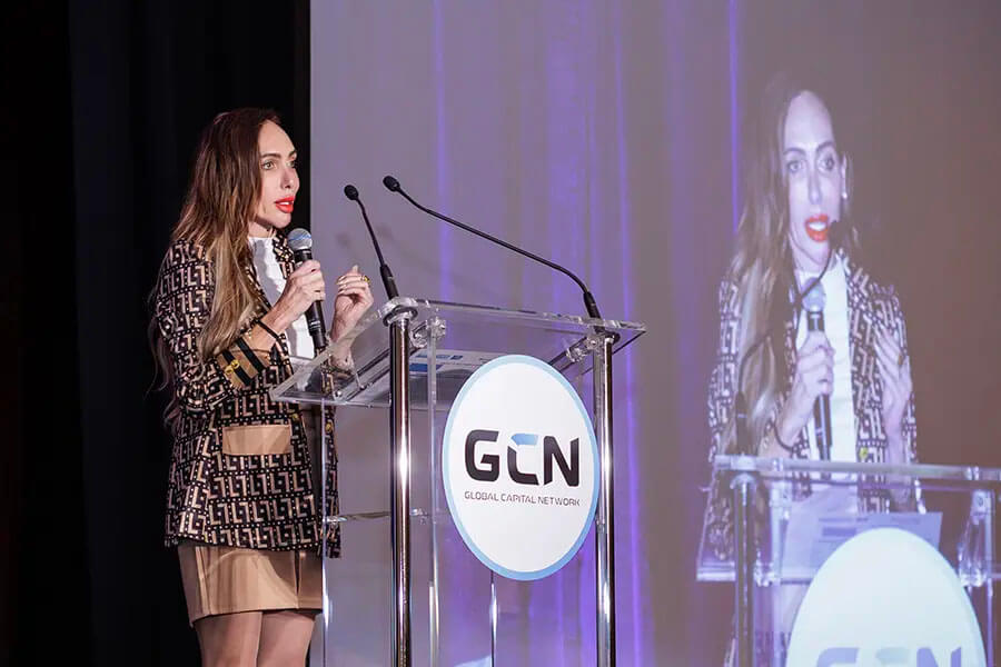 Annabella Gutman speaking on stage at Global Capital Network