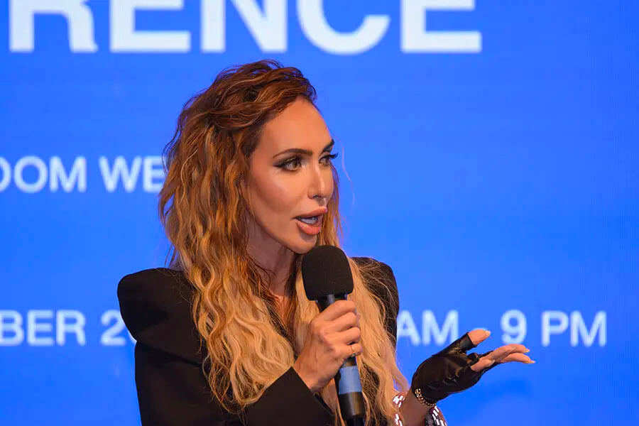 Annabella speaking with a handheld microphone